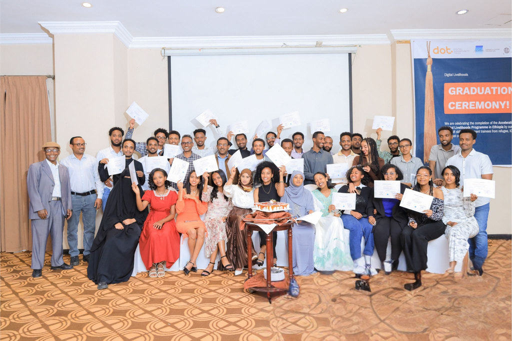 Na'amal cohort participants holding certificates at a graduation ceremony